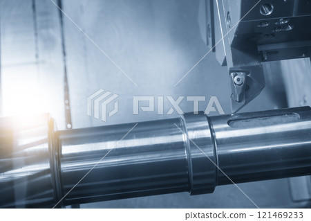 The  CNC lathe machine forming  cutting the metal shaft parts in the light blue scene with lighting effect. 121469233