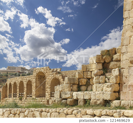 Roman ruins (against the background of a beautiful sky with clouds) in the Jordanian city of Jerash (Gerasa of Antiquity), capital and largest city of Jerash Governorate, Jordan Roman ruins (against the background of a beautiful sky with clouds) in the Jordanian city of Jerash (Gerasa of Antiquity), capital and largest city of Jerash Governorate, Jordan 121469629