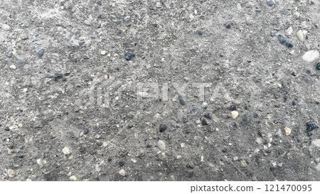 Textured surface of concrete with pebbles and small stones in daylight 121470095