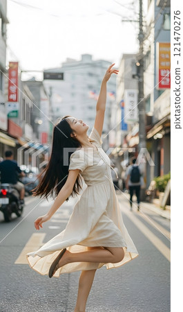 Graceful Woman Dancing Elegantly on a Busy City Street 121470276