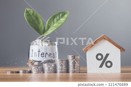 Stacks of coins arranged in ascending order with a small house model placed on a table, Home loan interest, mortgage refinancing, saving for housing, Planning for homeownership and stability Stacks of coins arranged in ascending order with a small house model placed on a table, Home loan interest, mortgage refinancing, saving for housing, Planning for homeownership and stability 121470889