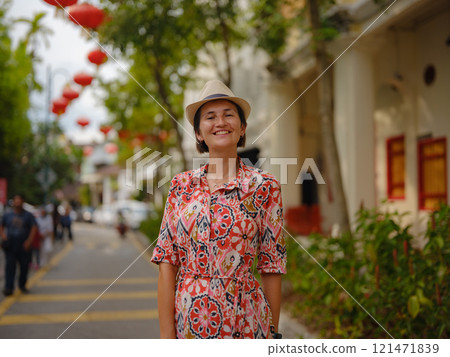woman exploring streets of George Town, during Chinese New Year. 121471839