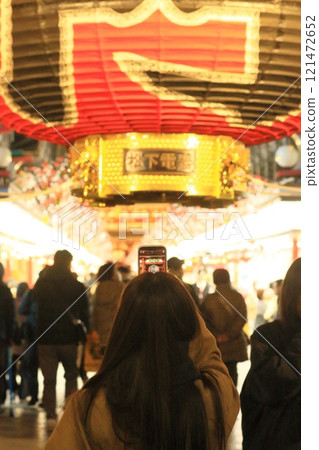 A woman photographing the lanterns at Kaminarimon Gate A woman photographing the night view A woman photographing the lanterns at Kaminarimon Gate A woman photographing the night view 121472652