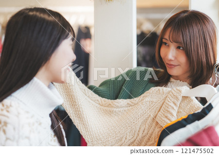 Two women choosing clothes while shopping [Photo courtesy of Nuttari Terrace Shopping Street] 121475502