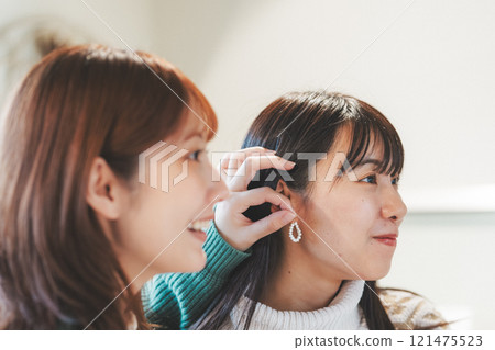 Two women choosing accessories while shopping [Photo courtesy of Nuttari Terrace Shopping Street] 121475523