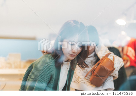 Two women choosing accessories while shopping [Photo courtesy of Nuttari Terrace Shopping Street] 121475556