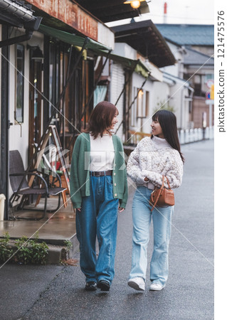 Two women walking through a retro-style shopping street [Photo courtesy of Nuttari Terrace Shopping Street] 121475576