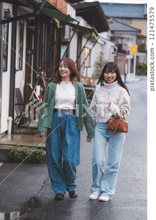 Two women walking through a retro-style shopping street [Photo courtesy of Nuttari Terrace Shopping Street] 121475579