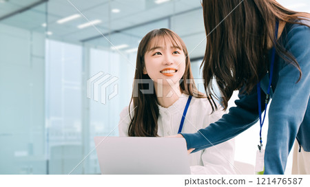 Two businesswomen using a computer Two businesswomen using a computer 121476587
