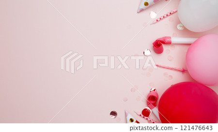 Concept of festive birthday celebrations. Birthday attributes colorful balloons, party hats, candles, and confetti 121476643