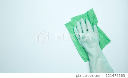 House cleaning. Womans hand in rubber glove holds cloths 121476663