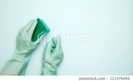 House cleaning. Woman hand in rubber glove holds dishwashing sponge 121476666