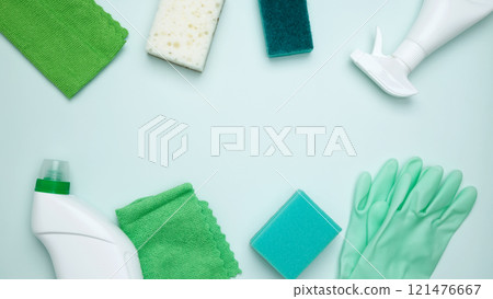 Cleaning supplies and tools, including bottles, gloves, sponges, and cloths. Concept of cleanliness and hygiene Cleaning supplies and tools, including bottles, gloves, sponges, and cloths. Concept of cleanliness and hygiene 121476667