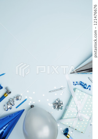 Concept of festive birthday celebrations. Birthday attributes colorful balloons, party hats, candles, confetti 121476676