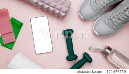 Sport equipment, dumbbells, foam roller for Myofascial release and smartphone for viewing home workouts, healthy lifestyle 121476759