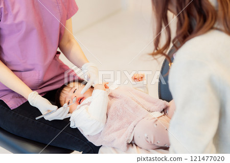 An anxious baby undergoing an infant checkup An anxious baby undergoing an infant checkup 121477020