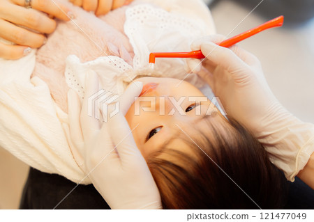 An anxious baby undergoing an infant checkup An anxious baby undergoing an infant checkup 121477049