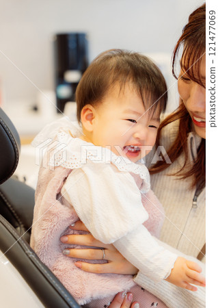 An anxious baby undergoing an infant checkup An anxious baby undergoing an infant checkup 121477069
