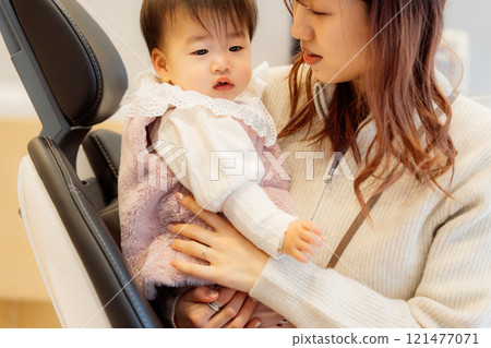 An anxious baby undergoing an infant checkup 121477071