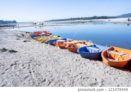 Colorful row boats on the beach of a small island in the Baltic Sea 121478449