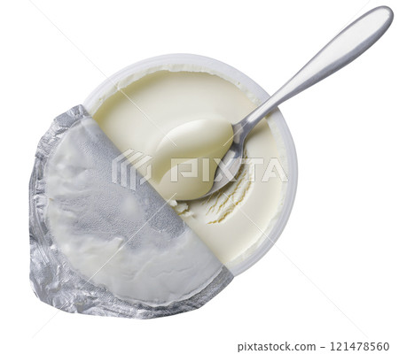 Mascarpone cream cheese in an open package with a spoon on a white background. Top view Mascarpone cream cheese in an open package with a spoon on a white background. Top view 121478560