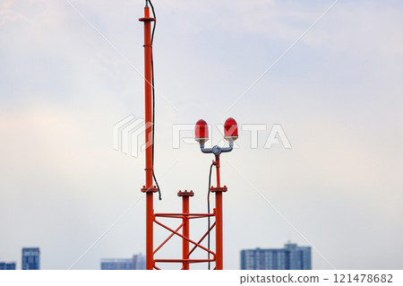 Obstruction light, an aircraft warning light on top of a highrise of building. 121478682