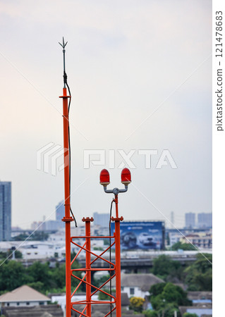 Obstruction light, an aircraft warning light on top of a highrise of building. 121478683