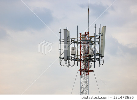 Wireless Communication Antenna pole, Mobile phone mast antenna pole on top of dilapidated building 121478686