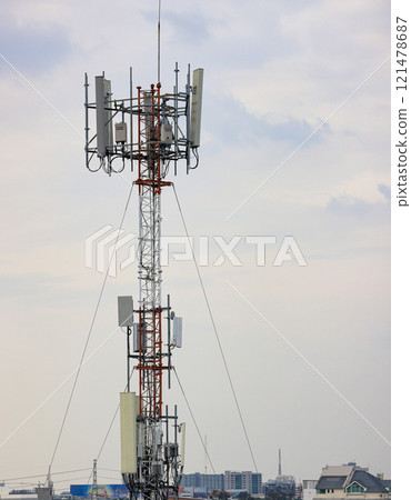 Wireless Communication Antenna pole, Mobile phone mast antenna pole on top of dilapidated building 121478687