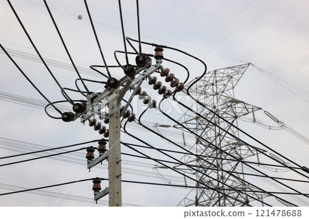 porcelain insulator on High voltage post, High voltage tower, show with high voltage construction and power lines. porcelain insulator on High voltage post, High voltage tower, show with high voltage construction and power lines. 121478688