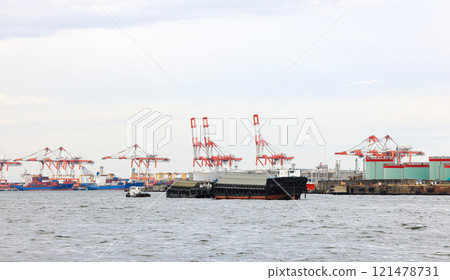 Container port at Osaka Japan, container crane at Industrial port for cargo container ship. Cargo transportation and activity at modern shipping container terminal. 121478731