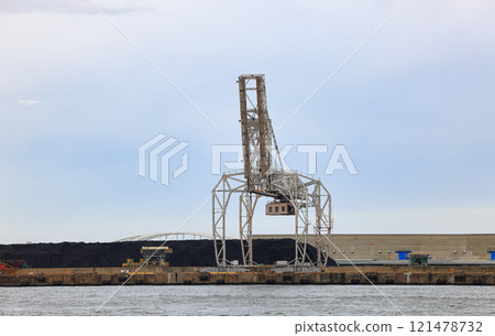 LargeLarge crane works on large coal stockpile at Osaka port. crane works on large coal stockpile at Osaka port. LargeLarge crane works on large coal stockpile at Osaka port. crane works on large coal stockpile at Osaka port. 121478732