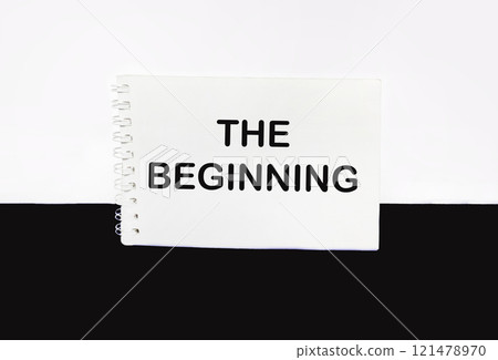Text, THE BEGINNING on a notepad and a beautiful white and black background 121478970