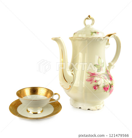 Elegant vintage porcelain coffee pot, porcelain cup and saucers isolated on white. Free space for text. Elegant vintage porcelain coffee pot, porcelain cup and saucers isolated on white. Free space for text. 121479566