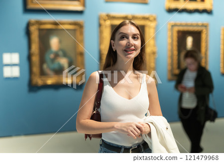 Girl view pictures and icons in museum hall 121479968