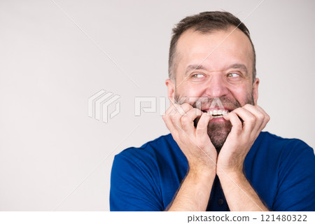Man biting his nails Man biting his nails 121480322