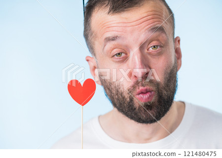 Adult man with heart on stick 121480475