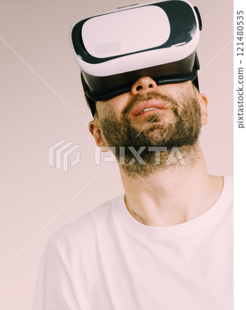 Adult man wearing vr goggles 121480535