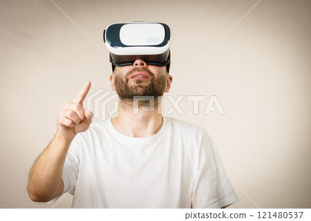 Adult man wearing vr goggles 121480537