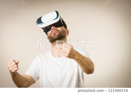 Adult man wearing vr goggles 121480539