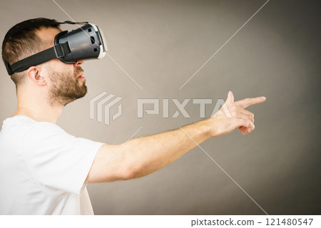 Adult man wearing vr goggles Adult man wearing vr goggles 121480547