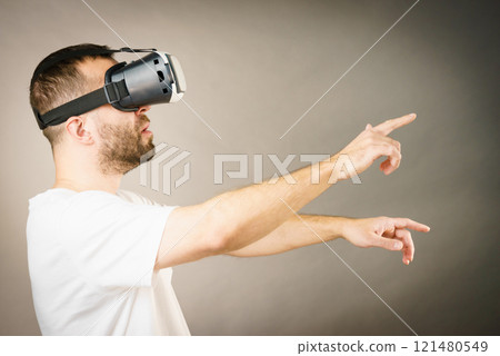 Adult man wearing vr goggles Adult man wearing vr goggles 121480549