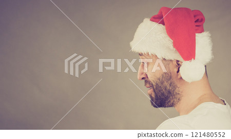 Bearded man in santa claus hat Bearded man in santa claus hat 121480552