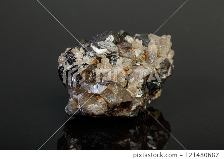 macro mineral cassiterite stone on gray background 121480687