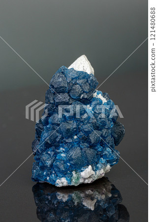 macro mineral stone Fluorite on quartz on a gray background macro mineral stone Fluorite on quartz on a gray background 121480688