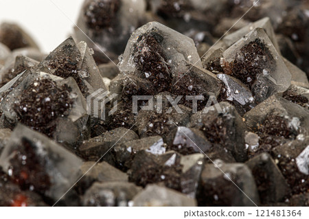 Macro of a stone Ilvaite mineral on a white background 121481364