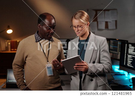 Discussing information on tablet screen Discussing information on tablet screen 121481965