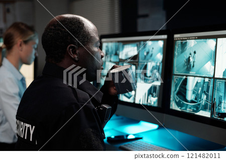 Officer in uniform having cup of coffee Officer in uniform having cup of coffee 121482011
