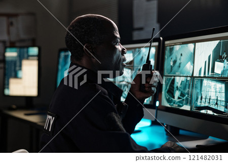Mature male guard with walkie-talkie 121482031