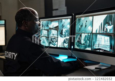 Concentrating on watching cctv video 121482032